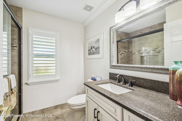 bathroom with a shower with door, crown molding, vanity, tile patterned flooring, and toilet