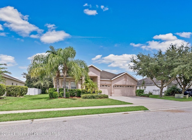 view of front of property with a garage and a front lawn