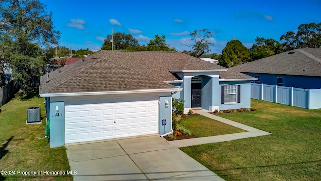 ranch-style home featuring a garage and a front yard