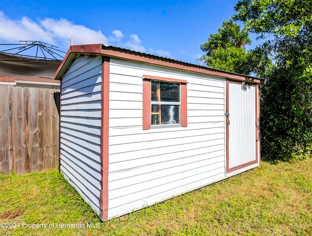 view of outbuilding with a lawn