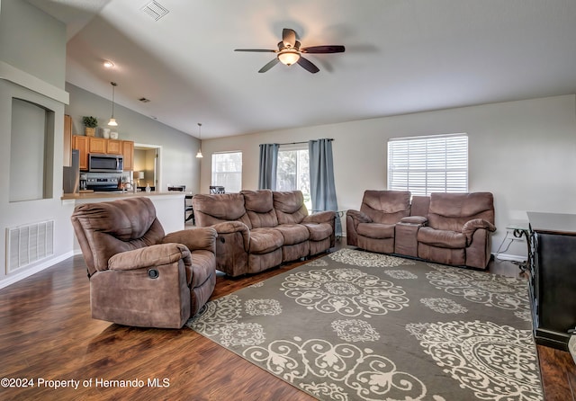 living room featuring dark hardwood / wood-style flooring, ceiling fan, and vaulted ceiling