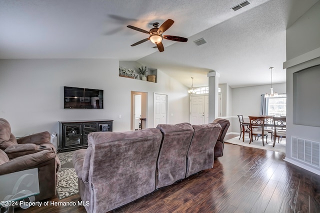 living room with dark wood-type flooring, ceiling fan with notable chandelier, a textured ceiling, and lofted ceiling