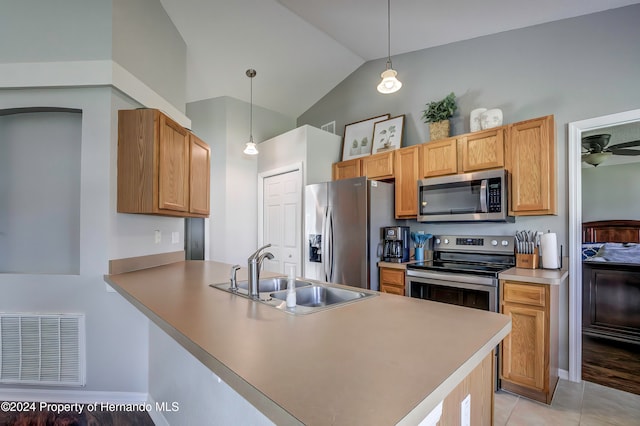 kitchen with stainless steel appliances, lofted ceiling, kitchen peninsula, hanging light fixtures, and sink