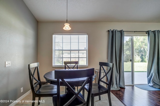 dining space featuring hardwood / wood-style flooring and a textured ceiling