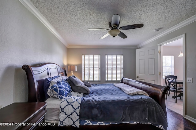 bedroom featuring hardwood / wood-style flooring, ceiling fan, multiple windows, and ornamental molding