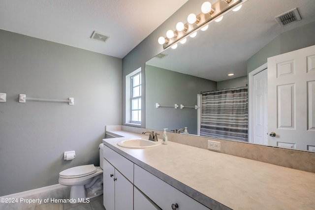 bathroom with toilet, vanity, tile patterned flooring, and curtained shower