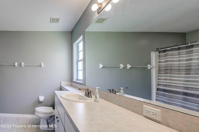 bathroom featuring toilet, a shower with curtain, vanity, and tile patterned floors