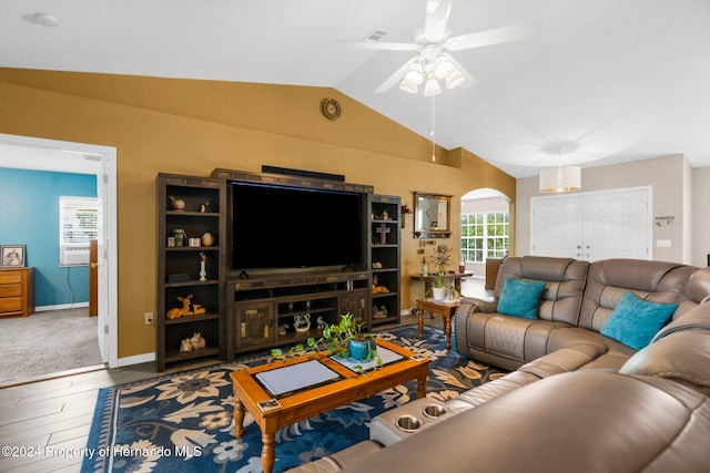 living room featuring hardwood / wood-style floors, a healthy amount of sunlight, ceiling fan, and vaulted ceiling