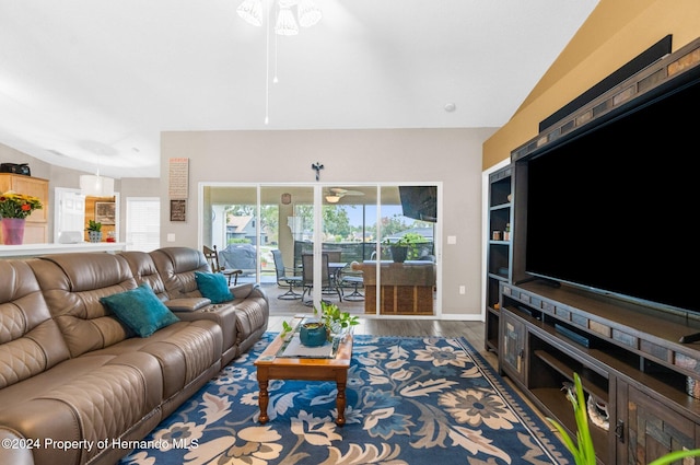 living room featuring lofted ceiling, hardwood / wood-style flooring, and ceiling fan