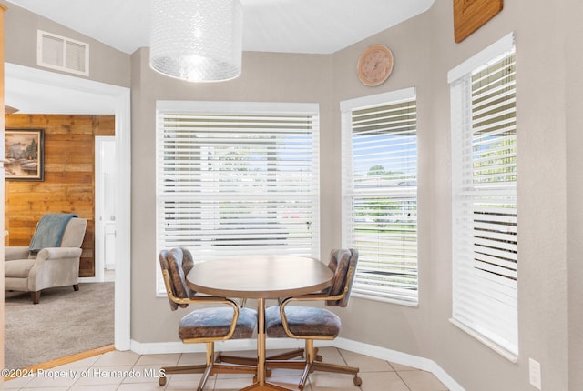 tiled dining space with wooden walls