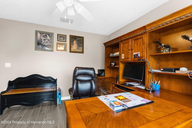 home office with hardwood / wood-style floors, ceiling fan, and a textured ceiling