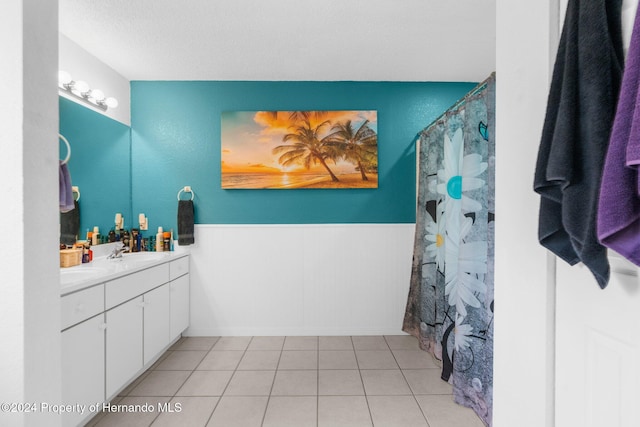 bathroom featuring a shower with curtain, tile patterned flooring, vanity, and a textured ceiling