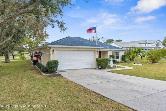 ranch-style home with a garage and a front lawn