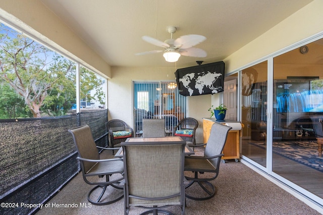 sunroom / solarium featuring ceiling fan