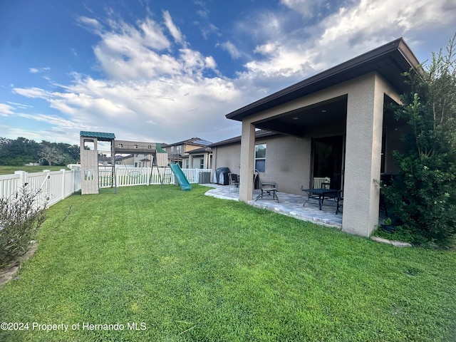 view of yard featuring a patio and a playground