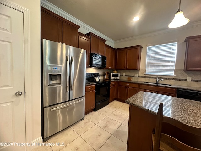 kitchen featuring black appliances, sink, ornamental molding, pendant lighting, and dark stone countertops