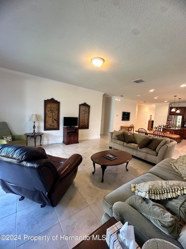 living room featuring a textured ceiling and light tile patterned floors