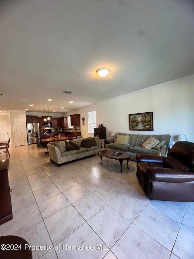 living room featuring ornamental molding and light tile patterned flooring