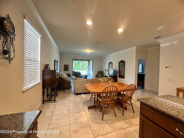 dining room with light tile patterned floors and ornamental molding