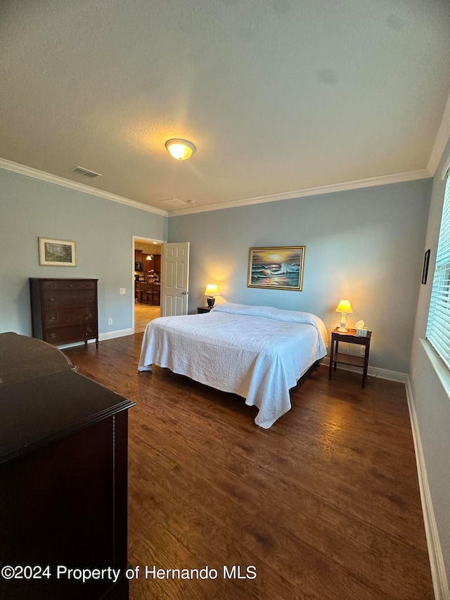 bedroom featuring dark wood-type flooring and ornamental molding