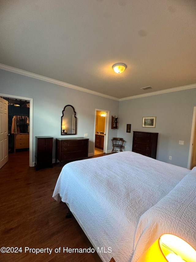 bedroom featuring ornamental molding and dark hardwood / wood-style floors