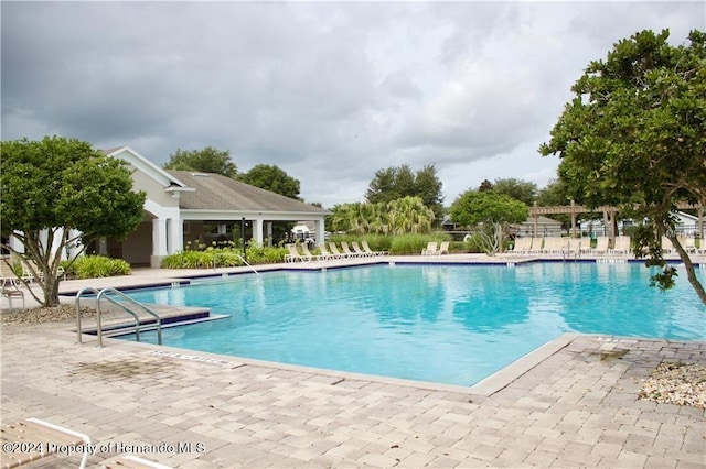 view of swimming pool with a patio