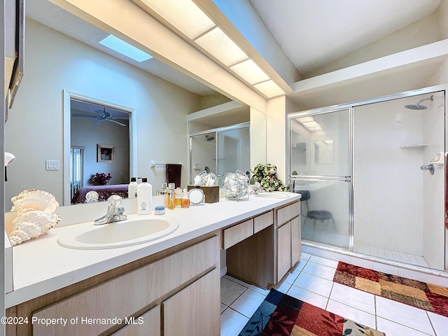 bathroom featuring tile patterned flooring, vanity, ceiling fan, and a shower with door