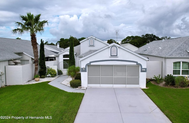 ranch-style home with a garage and a front yard