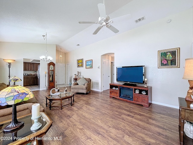 living room with dark hardwood / wood-style flooring, lofted ceiling, and ceiling fan with notable chandelier