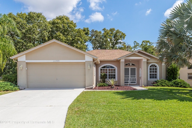 ranch-style house with a garage and a front yard