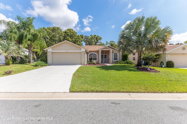 single story home featuring a front yard and a garage