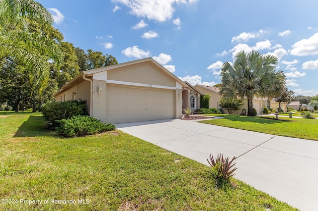 ranch-style home with a garage and a front lawn