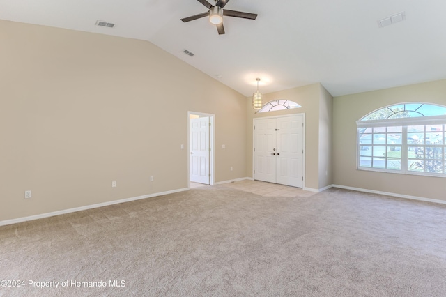 interior space featuring light carpet, ceiling fan, and vaulted ceiling