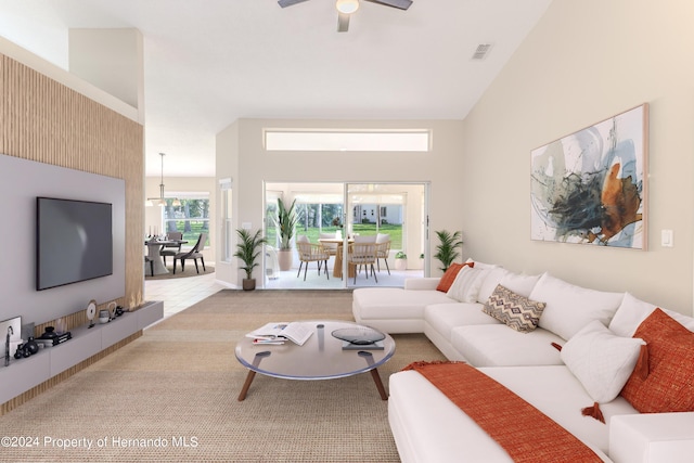 living room with ceiling fan, light colored carpet, and lofted ceiling