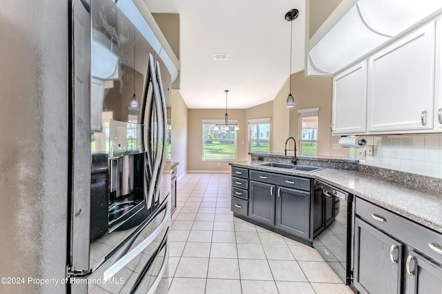 kitchen featuring sink, white cabinets, stainless steel fridge, pendant lighting, and black dishwasher