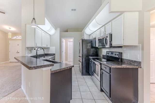 kitchen featuring stainless steel appliances, white cabinetry, light tile patterned floors, sink, and kitchen peninsula