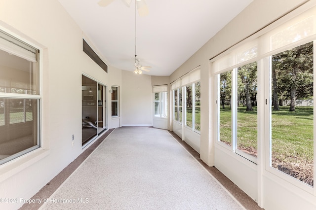 unfurnished sunroom with ceiling fan