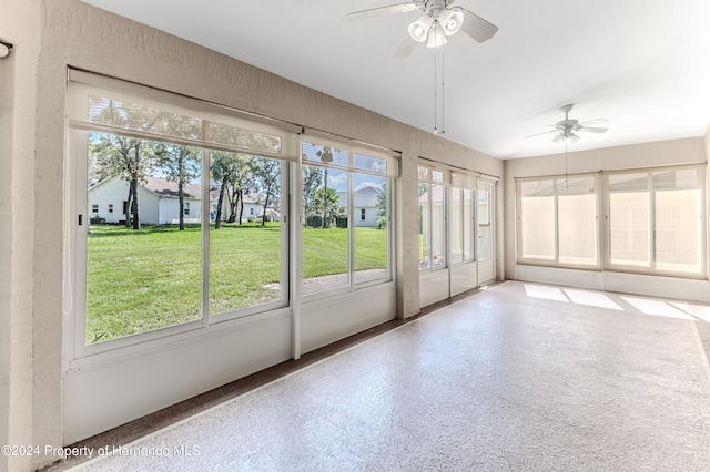 unfurnished sunroom featuring ceiling fan