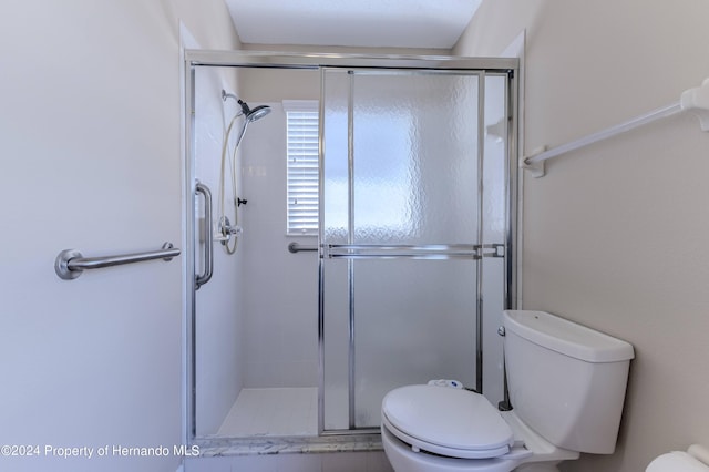 bathroom with walk in shower and toilet