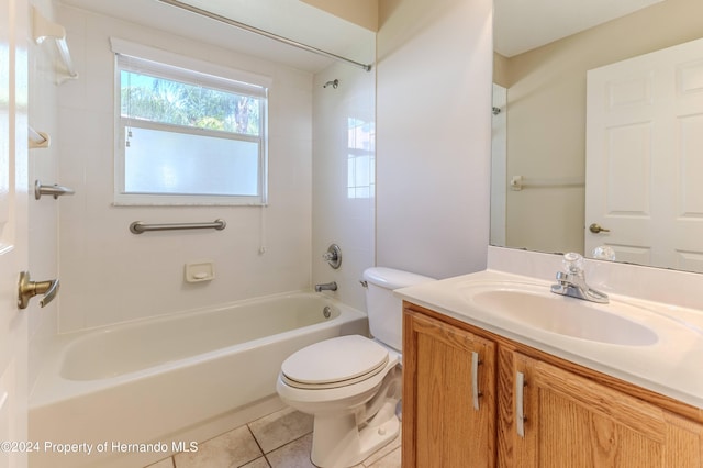 full bathroom featuring toilet, vanity, tiled shower / bath, and tile patterned flooring