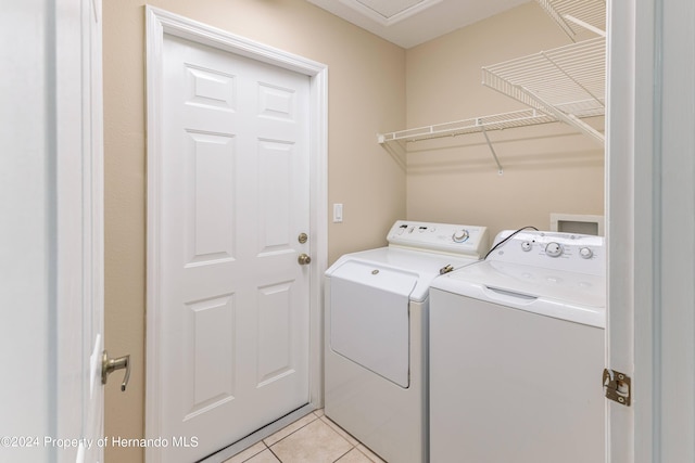 washroom featuring separate washer and dryer and light tile patterned floors