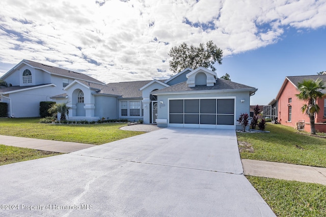 ranch-style home with a garage and a front lawn