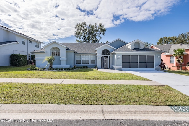 ranch-style home with a garage and a front yard