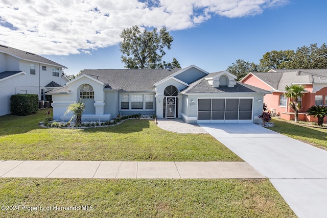 view of front of property with a front lawn and a garage