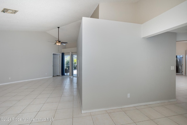 tiled spare room with a textured ceiling, high vaulted ceiling, and ceiling fan