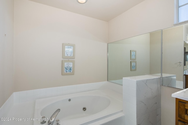 bathroom featuring vanity and a bath