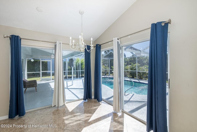 doorway to outside featuring light tile patterned floors, vaulted ceiling, and an inviting chandelier