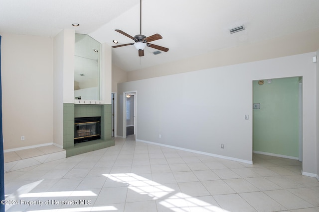 unfurnished living room featuring high vaulted ceiling, ceiling fan, a tile fireplace, and light tile patterned floors