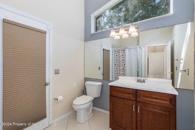 bathroom with toilet, vanity, tile patterned floors, and a shower with shower curtain