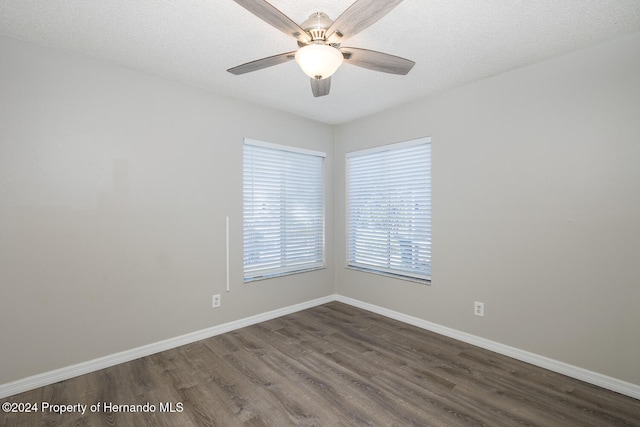 unfurnished room featuring a textured ceiling, dark wood-type flooring, and ceiling fan